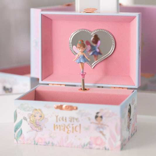 A pink jewelry box with a fairy design, featuring a mirrored lid and a musical note on the side, presumably playing the melody of a fairy tale.