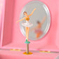 Open musical jewelry box showing a spinning ballerina figurine, interior mirror, and velvet-lined jewelry compartment.