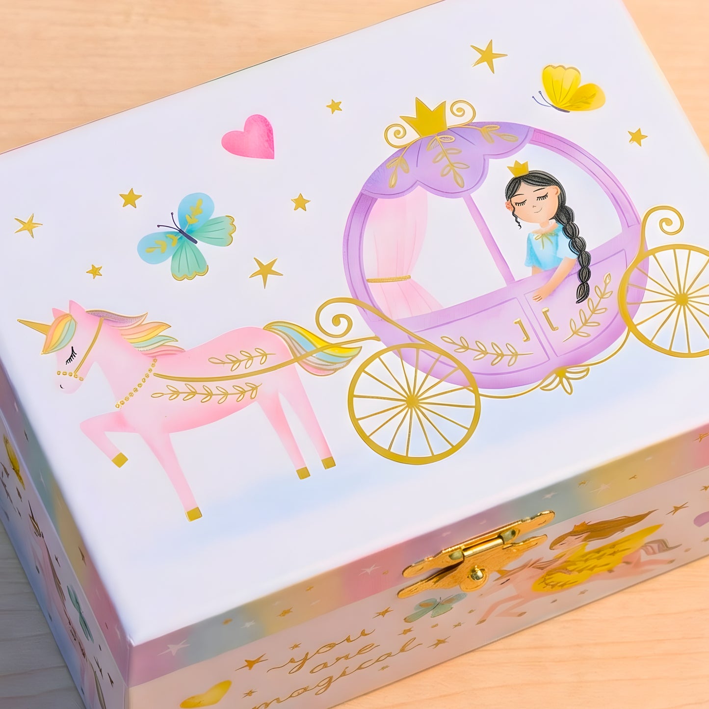Children's jewelry box with princess and unicorn design on a wooden surface