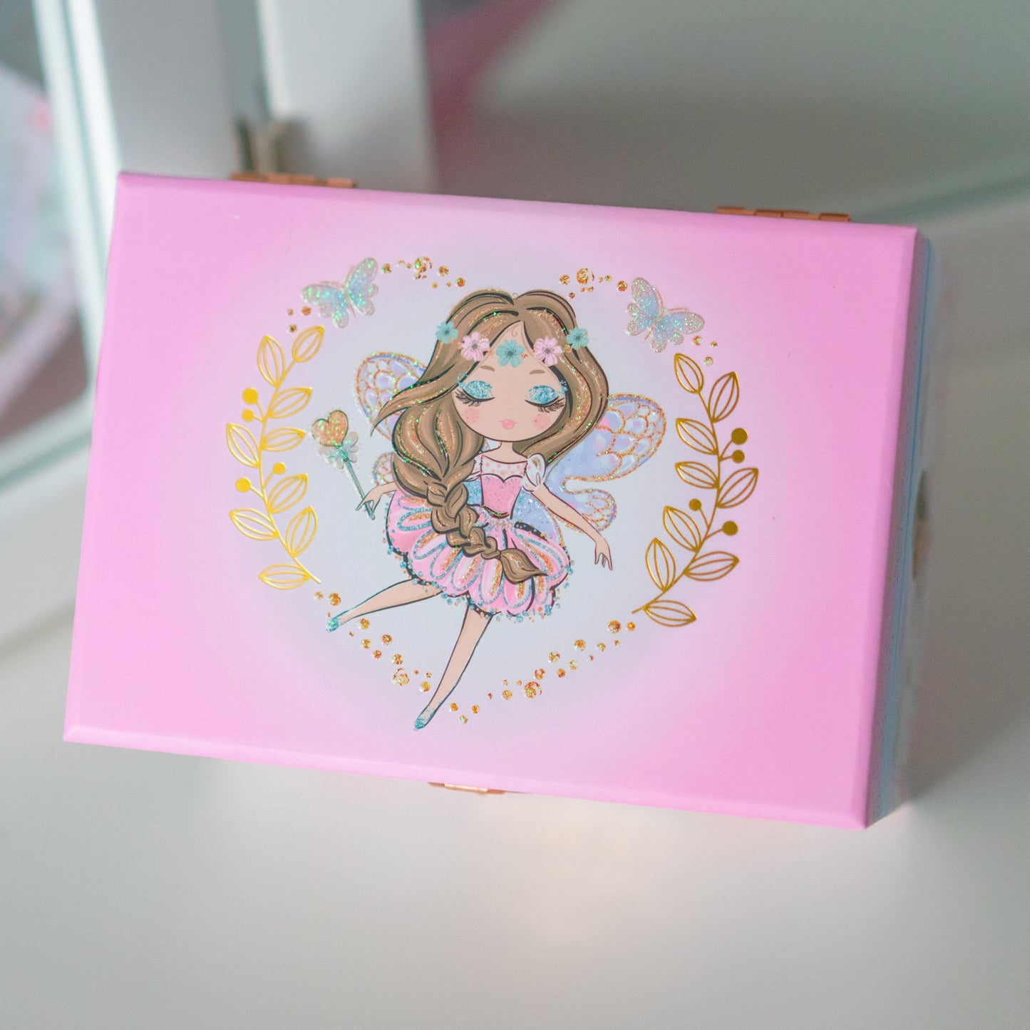 Pink jewelry box with a fairy illustration