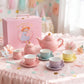 Pastel and gold polka dot porcelain tea set for girls with pink teapot, sugar bowl, milk pot, 4 pastel cups and saucers, and a pink carry case
