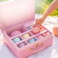 Child placing the pink milk jug into the pastel porcelain tea set's pink carry case, with cups organized in padded compartments outdoors