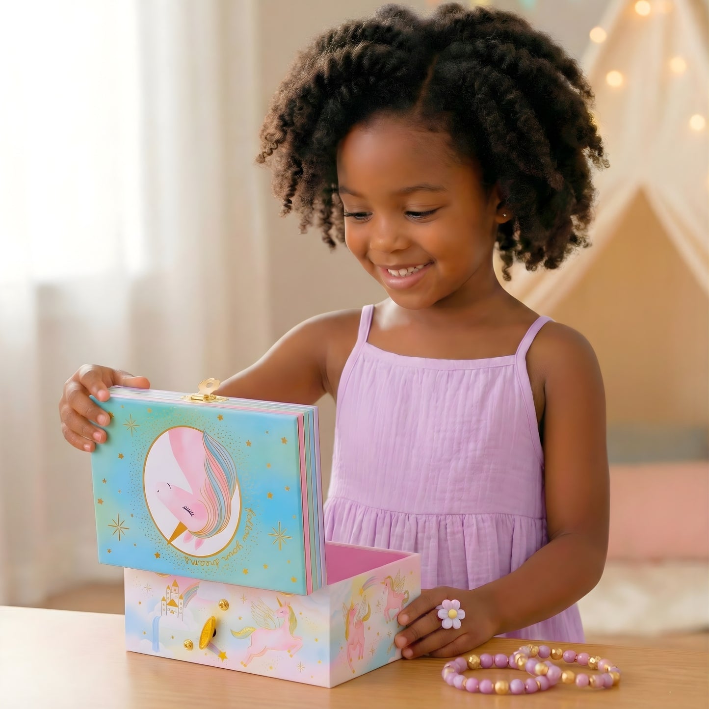 Child opening a colorful jewelry box with a unicorn design