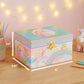 Pastel-colored jewelry box with unicorn design on a wooden surface with measurements.