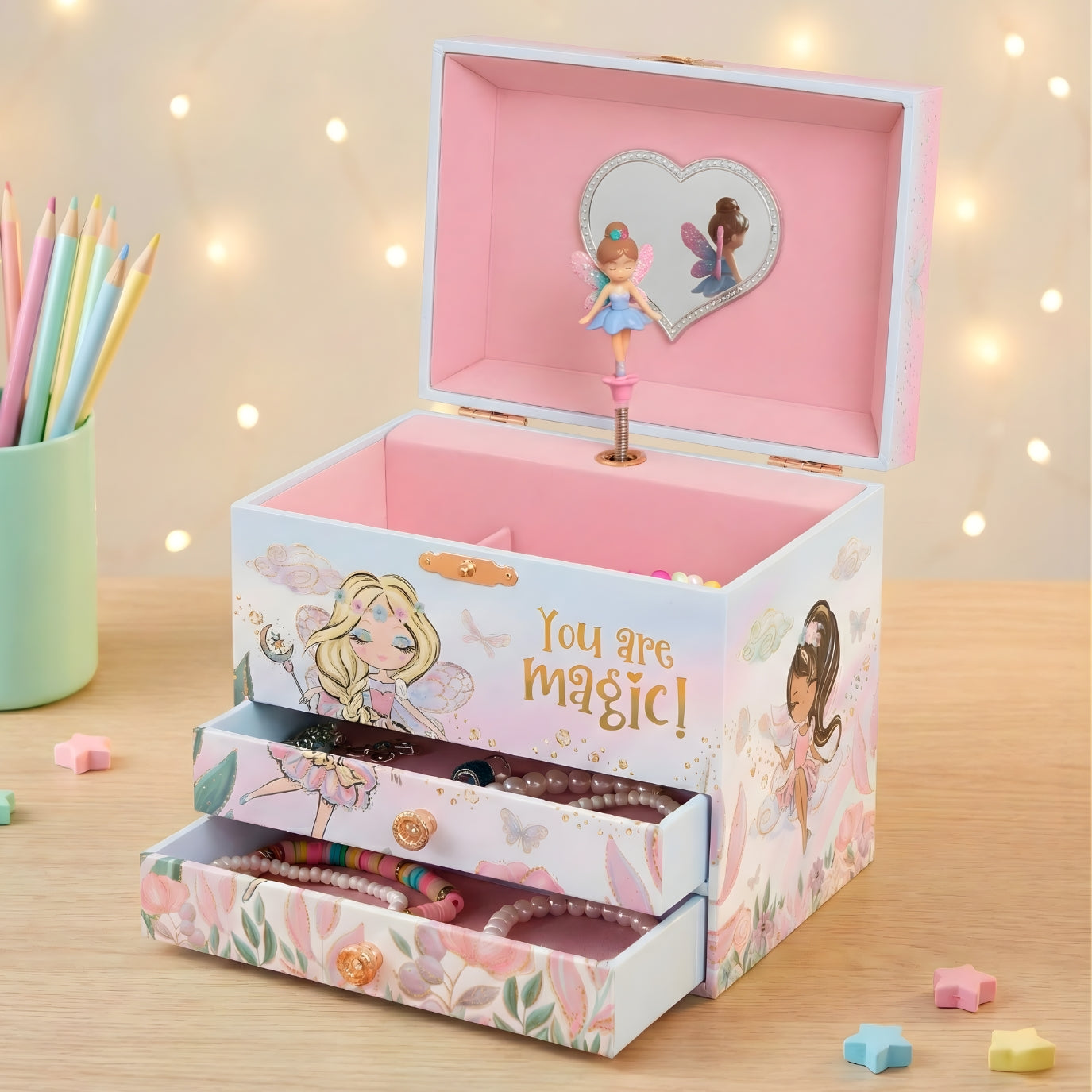 Children's jewelry box with fairy design and 'You are magic!' text on a wooden surface.
